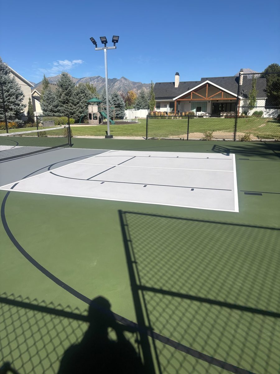 White pickleball lines and black basketball key striping on the rebuilt Lehi court