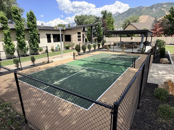 Green Backyard Tennis and Pickleball Court with Tan Surround, Pergola and Mountain View by Precision Pro Courts