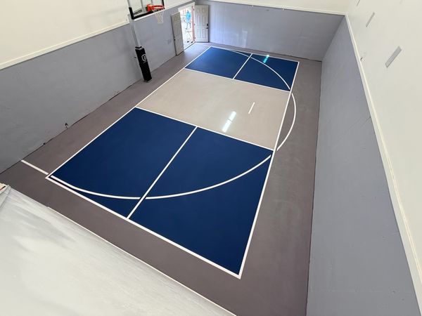 Indoor Garage Basketball and Pickleball Court with Navy Blue and Grey Surface by Precision Pro Courts